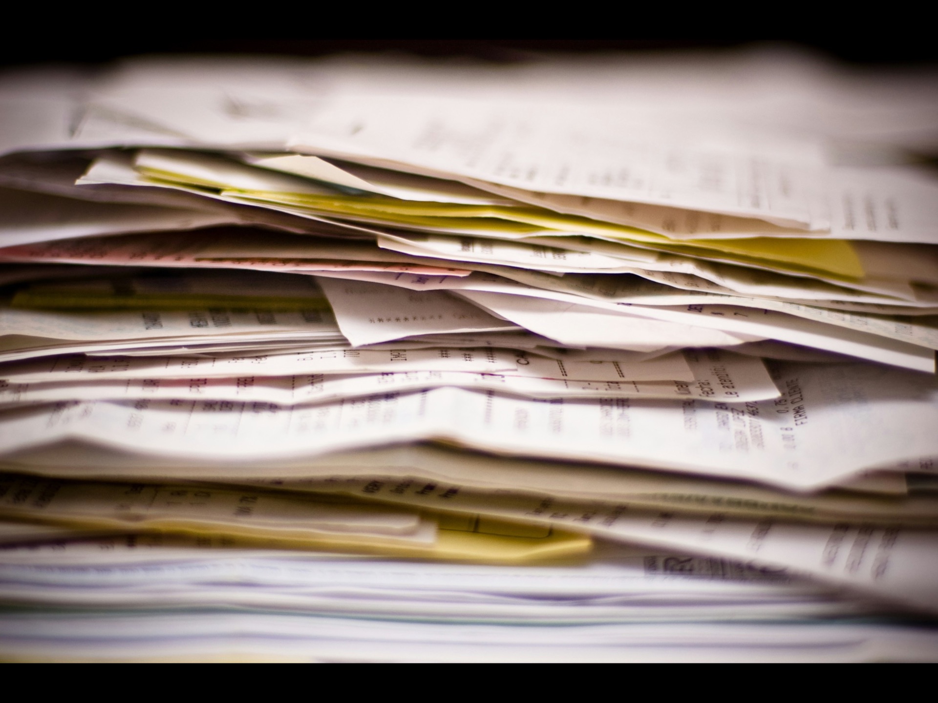 Stack of utility bills and paperwork for auditing